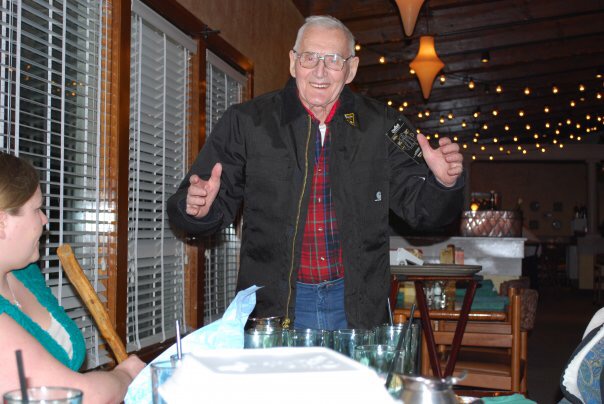 Wayne Lien smiling beside a restaurant table