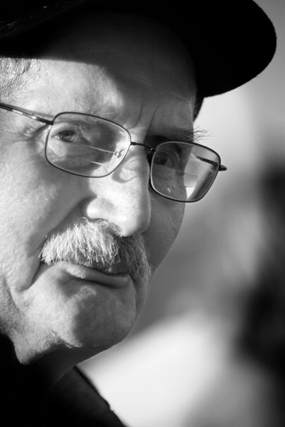 Wayne Lien wearing glasses and a cap